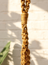Load image into Gallery viewer, Vintage 1970s natural fiber macramé plant hanger with braided knots, twisted cord details, and tassel

