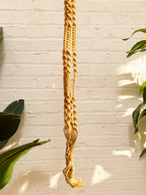 Load image into Gallery viewer, Vintage 1970s natural fiber macramé plant hanger with braided knots, twisted cord details, and tassel

