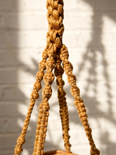Load image into Gallery viewer, Vintage 1970s natural fiber macramé plant hanger with braided knots, twisted cord details, and tassel

