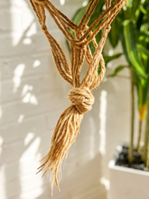 Load image into Gallery viewer, Vintage 1970s natural fiber macramé plant hanger with braided knots, twisted cord details, and tassel

