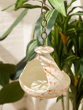 Load image into Gallery viewer, Vintage ceramic hanging bird feeder with cream glaze, orange-red speckles, open feeding area, and metal chain
