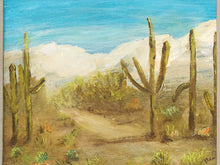 Load image into Gallery viewer, Vintage framed desert landscape painting with saguaro cacti, mountain backdrop, blue sky, and carved wood frame
