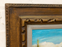 Load image into Gallery viewer, Vintage framed desert landscape painting with saguaro cacti, mountain backdrop, blue sky, and carved wood frame

