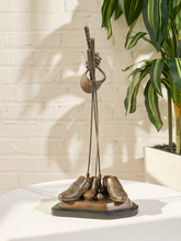 Load image into Gallery viewer, Vintage golf-themed metal floor sculpture with tall decorative form, golf clubs and balls in relief, and triangular base
