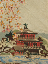 Load image into Gallery viewer, Vintage framed needlepoint artwork depicting a red pagoda, flowering tree branches, blue water, and distant mountains.

