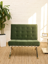 Load image into Gallery viewer, Vintage Barcelona-style lounge chair with olive green button-tufted seat and back, polished metal frame, and support straps
