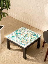 Load image into Gallery viewer, Vintage square side table with abstract green, orange, and yellow splatter-painted top and dark curved-leg base

