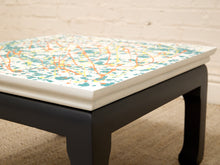 Load image into Gallery viewer, Vintage square side table with abstract green, orange, and yellow splatter-painted top and dark curved-leg base

