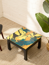 Load image into Gallery viewer, Vintage square side table with swirling yellow, orange, teal, and black marbled abstract top and dark curved-leg base
