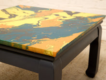 Load image into Gallery viewer, Vintage square side table with swirling yellow, orange, teal, and black marbled abstract top and dark curved-leg base
