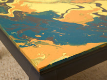Load image into Gallery viewer, Vintage square side table with swirling yellow, orange, teal, and black marbled abstract top and dark curved-leg base
