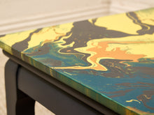 Load image into Gallery viewer, Vintage square side table with swirling yellow, orange, teal, and black marbled abstract top and dark curved-leg base
