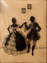 Load image into Gallery viewer, A vintage decorative wall hanging or plaque featuring black silhouette cutouts of a dancing couple on a warm beige background, with two small framed oval motifs near the top.
