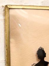Load image into Gallery viewer, Close-up of a framed art print with a distressed gold frame, a light beige background, and a black silhouette of a woman's profile in the lower right corner.
