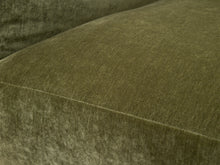 Load image into Gallery viewer, Close-up of a textured olive green velvet or velour fabric surface with a stitched seam and soft lighting.
