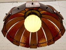 Load image into Gallery viewer, A vintage-style pendant light with a dome-shaped shade made of overlapping warm brown and amber wood slats, surrounding a glowing white ribbed glass bulb.
