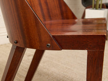 Load image into Gallery viewer, Close-up of a mid-century modern wooden chair with a glossy dark brown finish, showing the seat, backrest, and legs on a light beige carpet.
