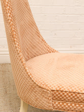 Load image into Gallery viewer, Close-up of a woven upholstered chair in a warm peach-beige color, showing the textured pattern on the seat and back, set against a white brick wall and light rug.
