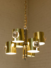 Load image into Gallery viewer, Vintage Space Age chandelier with polished brass cylindrical shades, mirrored chrome spheres, multiple lights, and chain suspension
