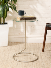Load image into Gallery viewer, Vintage round bar table with clear glass top, slender chrome pedestal, circular metal base, and angular support detail
