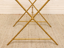 Load image into Gallery viewer, Gold metal folding table legs with a bamboo-inspired jointed design, shown on a textured beige rug against a white wall.
