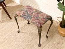 Load image into Gallery viewer, Vintage bench with tapestry-style floral upholstered seat and ornate curved metal legs with decorative foliate details
