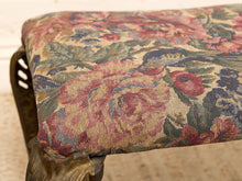 Load image into Gallery viewer, Close-up of a floral tapestry upholstered bench seat with a dark carved wooden frame, showing detailed rose and leaf patterns in pink, red, green, and beige.
