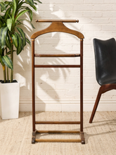 Load image into Gallery viewer, Vintage wooden gentleman’s valet stand with sculpted shoulder hanger, upper rail, accessory shelf, and lower trouser bars
