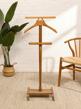 Load image into Gallery viewer, Vintage wooden gentleman’s valet stand with sculpted shoulder hanger, long upper rail, divided accessory tray, turned post, and freestanding base
