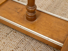 Load image into Gallery viewer, Close-up of a wooden furniture base or stand with a turned wooden leg post and silver metal guide rails on a woven beige rug.
