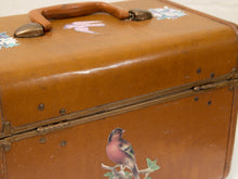 Load image into Gallery viewer, A vintage brown leather suitcase or trunk with a wooden handle, brass hardware, and painted bird and floral decals.
