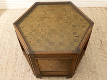 Load image into Gallery viewer, Hexagonal wooden end table with a cork-patterned top and dark wood frame, shown on a woven jute rug.
