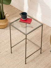 Load image into Gallery viewer, Vintage tall bar table with square clear glass top, slender aged metal frame, horizontal crossbars, and open geometric design
