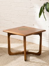 Load image into Gallery viewer, Distressed Mid-Century Lane wood side table with rounded square top, circular decorative detail, curved legs, and crossed base
