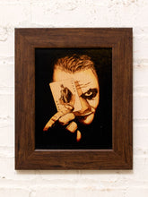 Load image into Gallery viewer, Vintage framed Joker portrait artwork in warm sepia and brown tones with a dark wood frame and theatrical character composition
