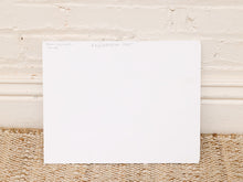 Load image into Gallery viewer, A blank white rectangular art print or paper sheet with handwritten text at the top, displayed against a white brick wall and woven beige rug.
