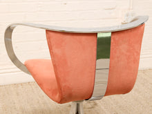 Load image into Gallery viewer, A mid-century modern swivel chair with a curved polished chrome frame and a coral pink velvet upholstered seat and backrest, featuring a vertical chrome accent strip.
