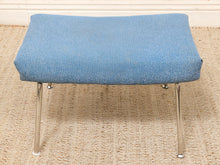 Load image into Gallery viewer, A mid-century modern stool with a textured blue fabric seat cushion and chrome metal legs, set on a woven jute rug.
