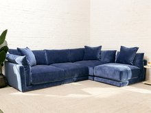 Load image into Gallery viewer, Hansel four-piece sectional sofa in Andrew Ocean blue upholstery with deep cushioned seating, loose back pillows, and chaise sections

