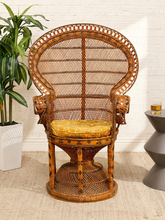 Load image into Gallery viewer, Vintage 1970s wicker peacock chair with oversized fan-shaped back, intricate woven rattan details, scrolling arms, pedestal base, and patterned seat cushion
