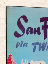 Load image into Gallery viewer, A close-up of a vintage-style metal sign with a light blue background, featuring the words 'San.
