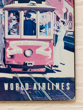Load image into Gallery viewer, Vintage-style World Airlines poster print featuring a pink trolley on tracks, mounted against a white brick wall.
