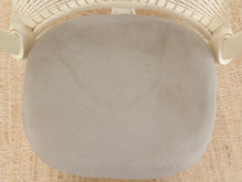 Load image into Gallery viewer, A close-up top-down view of a light gray fabric office chair cushion on a white chair, set on a beige woven rug.
