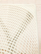 Load image into Gallery viewer, Close-up of a white mesh chair back showing the diamond-pattern slatted plastic material and rounded top corner.
