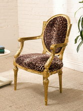 Load image into Gallery viewer, Antique French Louis XVI style giltwood armchair with carved frame, oval back, fluted legs, and brown leopard-print upholstery
