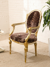 Load image into Gallery viewer, Antique French Louis XVI style giltwood armchair with carved frame, oval back, fluted legs, and brown leopard-print upholstery

