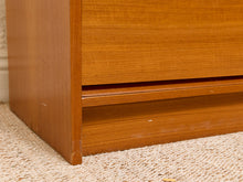 Load image into Gallery viewer, Close-up of a wooden furniture piece, showing the corner joint and drawer base on a beige textured carpet.

