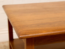 Load image into Gallery viewer, Close-up of a mid-century modern wooden table with a rich warm brown finish, showcasing the grain and rounded corners.
