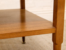 Load image into Gallery viewer, Close-up detail of a mid-century modern wooden side table, showing the warm brown wood grain of the shelves and legs against a neutral background.
