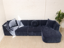 Load image into Gallery viewer, Bonnie three-piece sectional sofa in Amici Indigo blue upholstery with left-arm-facing loveseat, armless section, right-arm-facing chaise, and loose pillows

